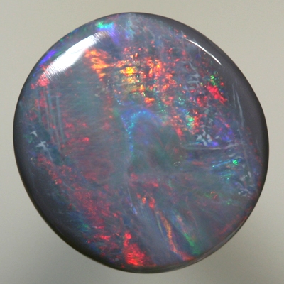 SOLID SEMI BLACK OPAL bright red moves over ocean blue green SEE VIDEO